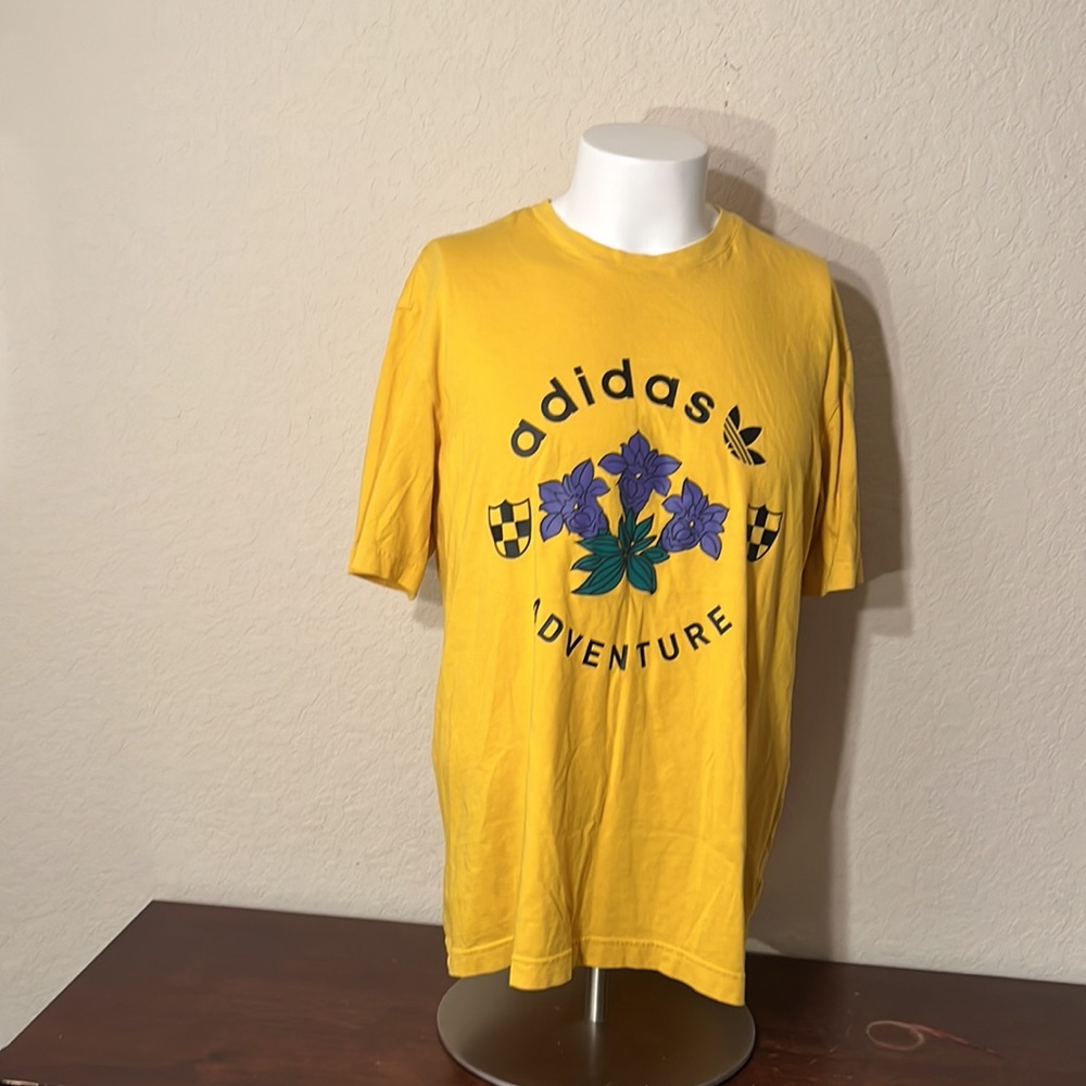 A yea low and purple Adidas shirt flower designs